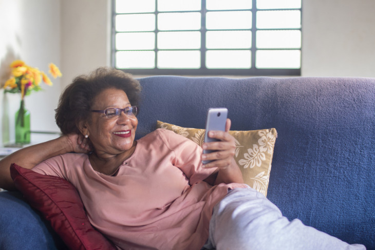 Older Latina woman on a couch