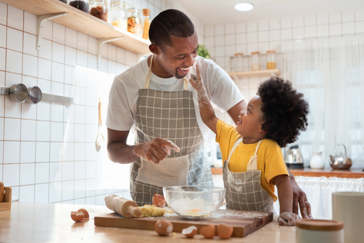 Father cooking with kid