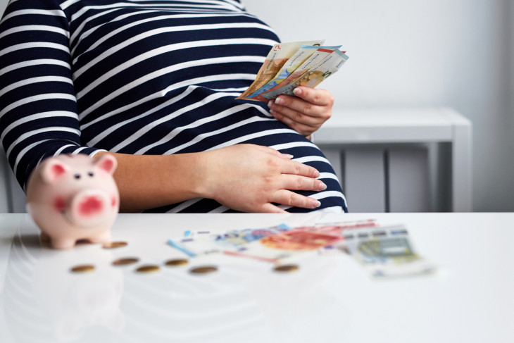 Close up of pregnant woman counting money