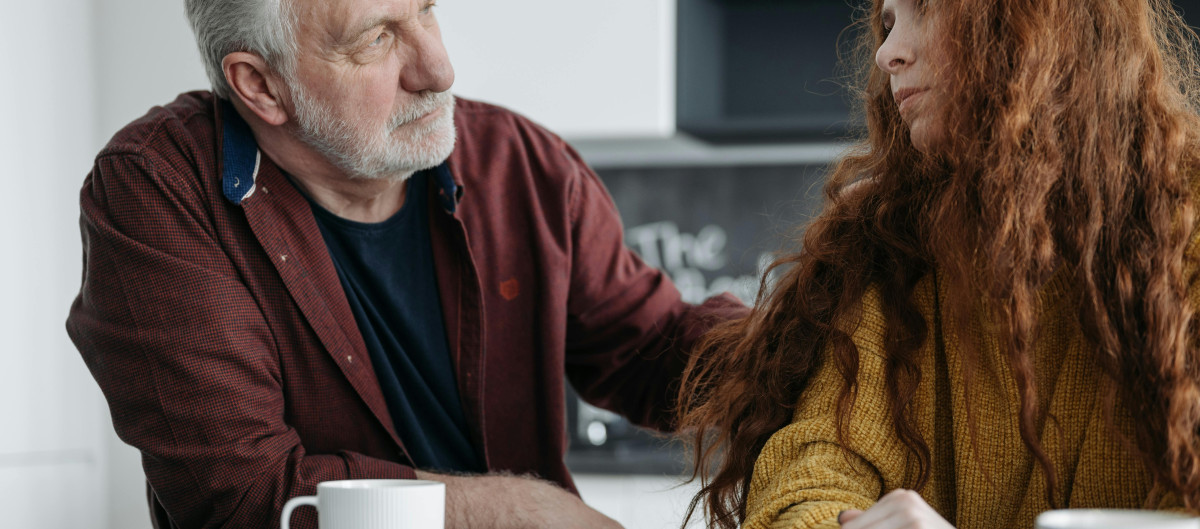 An older man consoling a young woman
